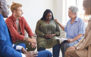 Portrait of young woman sharing struggles during a substance use intervention support group meeting